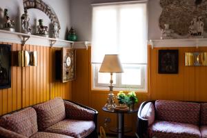 a living room with two chairs and a lamp at Residenza d'Epoca Albergo Quattro Fontane in Venice-Lido