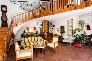a living room with a table and chairs and a staircase at Residenza d'Epoca Albergo Quattro Fontane in Venice-Lido