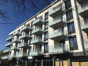 an apartment building with balconies on a street at Apartament Solna 11 in Kołobrzeg