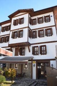 a building with tables outside of it at Ebrulu Konak in Safranbolu