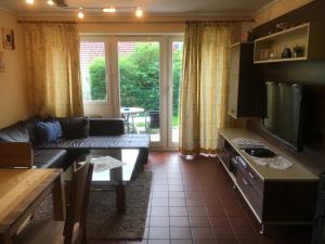 a living room with a couch and a table at Apartmentanlage am Kellerberg in Zandt