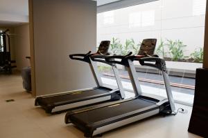 two treadmill machines in a room with a window at Bonjour My Vera in Buenos Aires