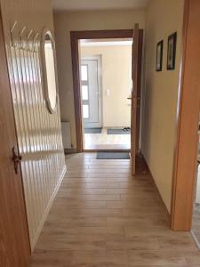 a hallway with a door leading into a room at Fewo Ramin in Felchow +8 photos