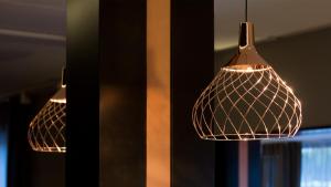 a couple of lights hanging from a ceiling at G Hotel Pescara in Pescara
