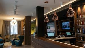 a lobby with a bar with two computers on it at G Hotel Pescara in Pescara