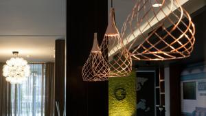 a couple of lights hanging from a ceiling at G Hotel Pescara in Pescara