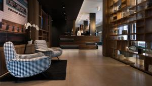 a lobby with two chairs and a counter at G Hotel Pescara in Pescara
