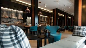 a restaurant with blue chairs and tables and a bar at G Hotel Pescara in Pescara