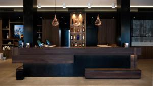 a bar in a restaurant with pendant lights at G Hotel Pescara in Pescara