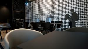 a dining room with a table and chairs with a guitar on the wall at G Hotel Pescara in Pescara