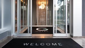 a welcome mat in front of a hotel door at G Hotel Pescara in Pescara