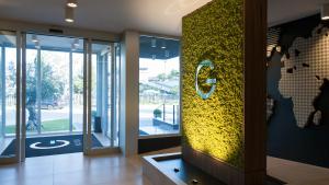 a lobby of a building with a yellow wall at G Hotel Pescara in Pescara