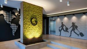 a lobby with a wall mural of a skateboarder at G Hotel Pescara in Pescara