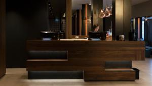 a woman sitting at a counter with a laptop at G Hotel Pescara in Pescara