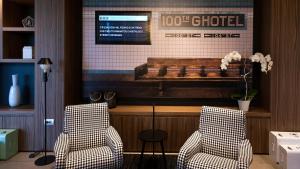 two chairs in front of a bar with a piano at G Hotel Pescara in Pescara