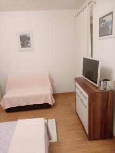 Postel nebo postele na pokoji v ubytování Apartmani Lomar
