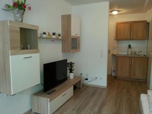 a living room with a flat screen tv on a wall at Ferienwohnung "Elsnerstrasse" in Nuremberg