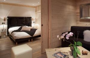 Postel nebo postele na pokoji v ubytování Hotel Les Mélèzes