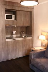 a living room with a couch and a microwave at Hôtel Albion in Ajaccio