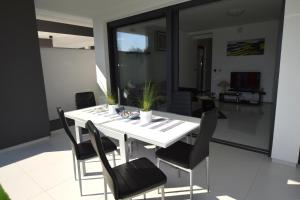 a white table and chairs in a living room at Apartment Helena in Malinska