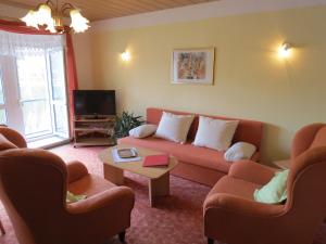 a living room with a couch and chairs and a tv at Hotel-Pension SCHLOSS -MIRAMAR in Bad Elster