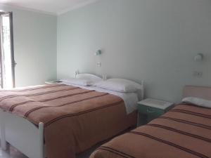 a bedroom with two beds and a window at La Lucciola Albergo Ristorante in Tagliacozzo