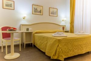 a hotel room with a bed and a table and a desk at Best Suites Pantheon in Rome