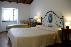a hotel room with two beds and a window at L'Antica Pieve Bed & Breakfast in Levanto