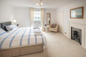 a bedroom with a bed and a fireplace at Cliffhanger 18 Castle Road in Cowes