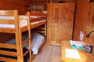 a room with two bunk beds in a cabin at La Boutique in Rossinière