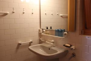 a bathroom with a sink and a mirror at La Boutique in Rossinière +13 photos