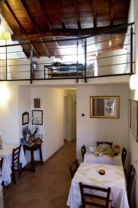 a dining room with two tables and a balcony at L'Antica Pieve Bed & Breakfast in Levanto