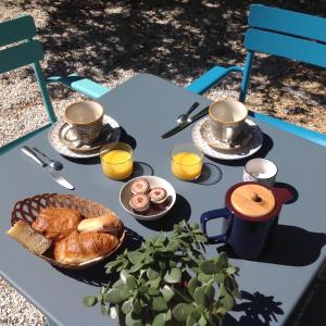 a table with cups and plates of food on it at Les Lauriers in Saint-Tropez +59 photos