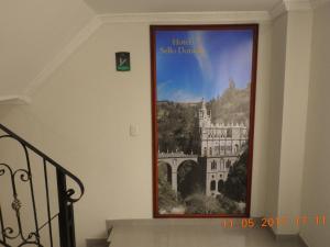 a picture of a building on the wall at Hotel Sello Dorado in Pasto