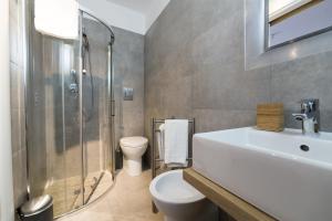 a bathroom with a sink and a toilet and a shower at Suite Inn Catania in Catania +32 photos