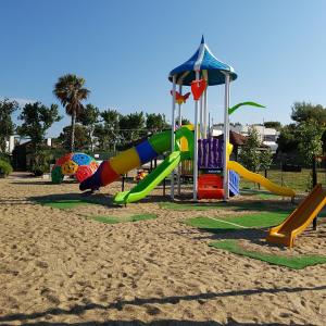 a playground with a slide at Residence Camping Atlantide in Monopoli
