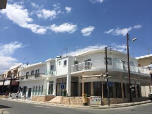 a white building on the corner of a street at Cross Road in Ayia Napa