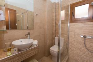 a bathroom with a sink and a toilet and a shower at AKANTHUS STUDIOS - Ex Vergos Pavlos in Parga +31 photos