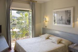 Postel nebo postele na pokoji v ubytování Hotel Mignon