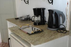 a kitchen counter with a coffee maker and a toaster at Apano Vrysi in Tinos