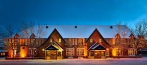 a large brick building in the snow at night at The Wort Hotel in Jackson
