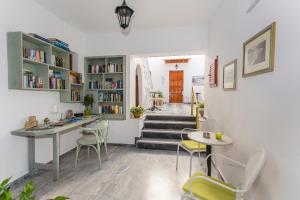 a room with a table and chairs and a staircase at AKANTHUS STUDIOS - Ex Vergos Pavlos in Parga