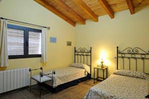 a bedroom with two beds and a window at Cielo Abierto in Berzocana