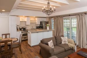 a living room with a couch and a kitchen at On the River Inn in Woodstock