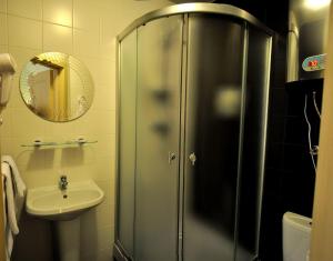 a bathroom with a shower and a sink at Avantazh Hotel in Saratov