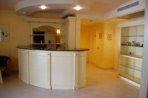 a large kitchen with a counter in a room at Hotel Primula in San Giovanni Rotondo