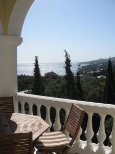 a balcony with a table and chairs and the ocean at Marat Park Hotel in Gaspra