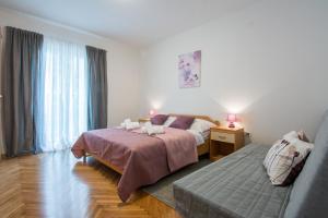 Posteľ alebo postele v izbe v ubytovaní Melita Center Apartment