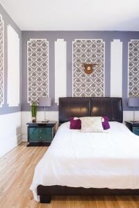 a bedroom with a large bed and two night stands at MtlVacationRentals - Appartements Plateau-Mont-Royal in Montréal