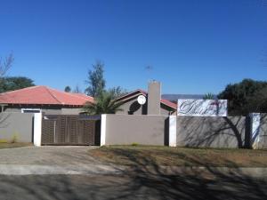 a white fence in front of a house at Dudsk Bed & Breakfast in Newcastle